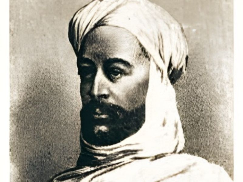Portrait of a man wearing a turban and traditional clothing, facing slightly to the side